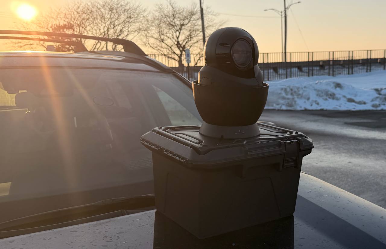 Compact interior-mounted vehicle camera system with one-way concealment materials